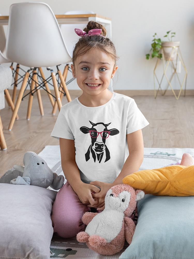 a girl sitting on a bed with stuffed animals