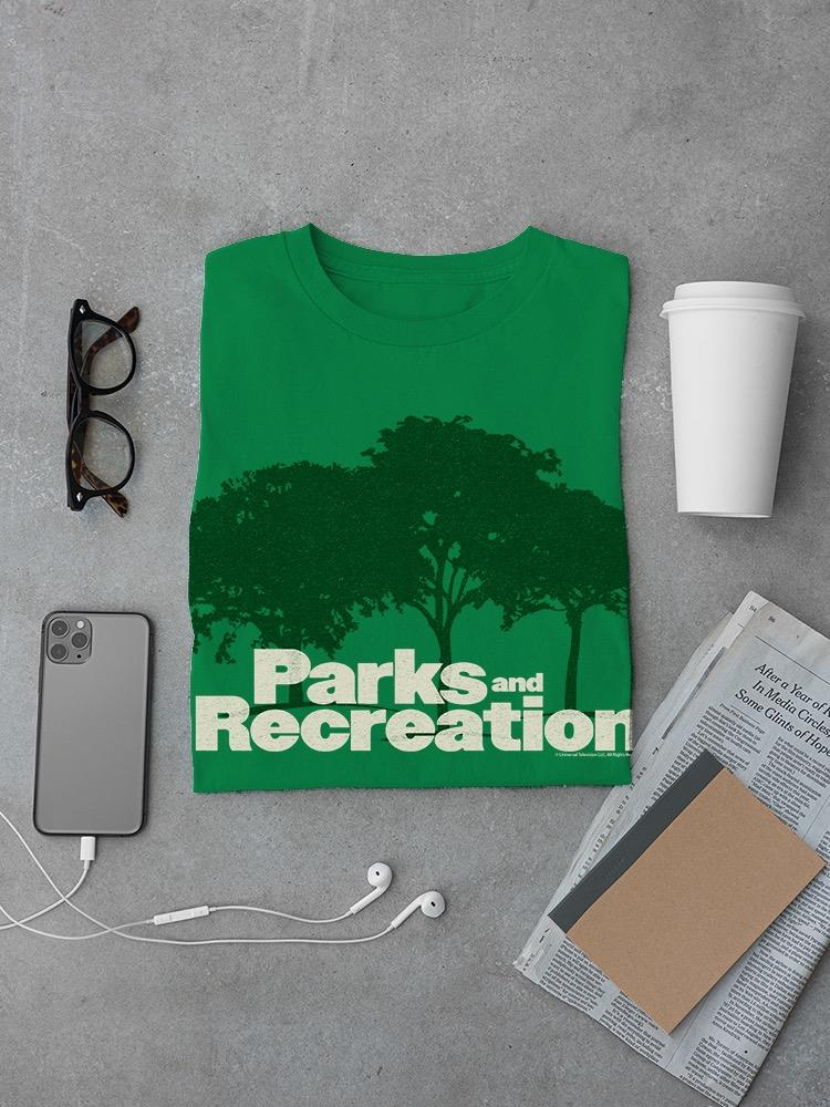 a green shirt with white text and a phone and glasses