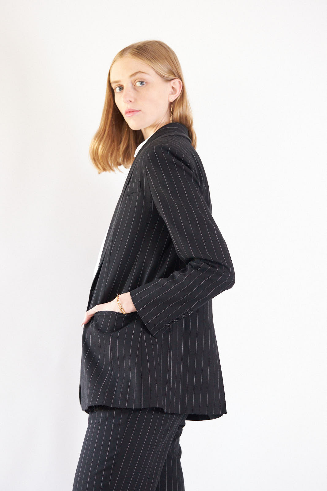 a woman in a pinstriped suit