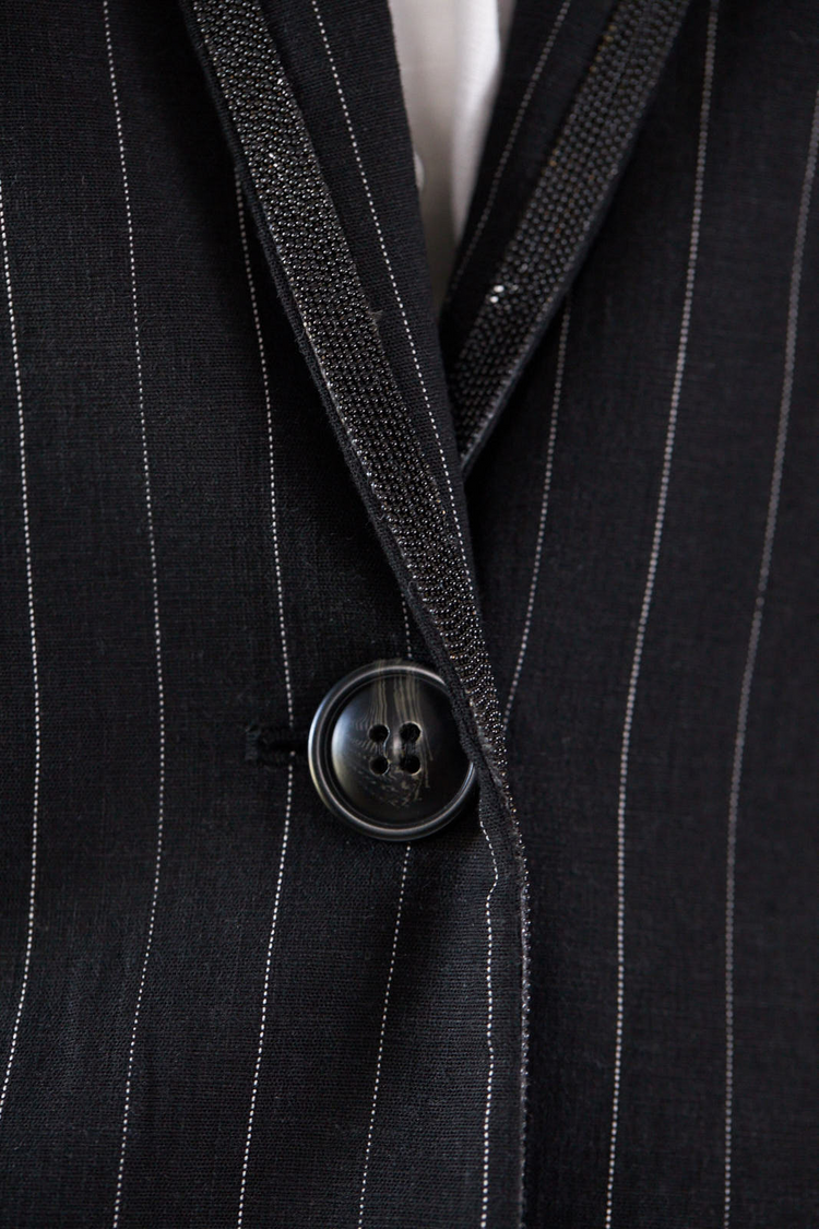 a close up of a button on a suit
