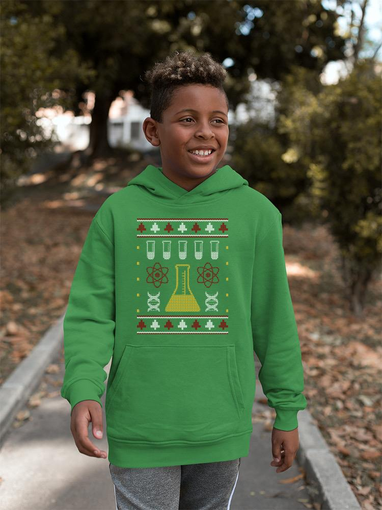 a boy wearing a green sweater
