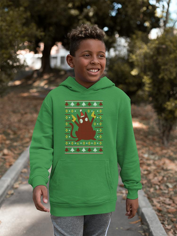 a boy wearing a green sweater with a cartoon character on it