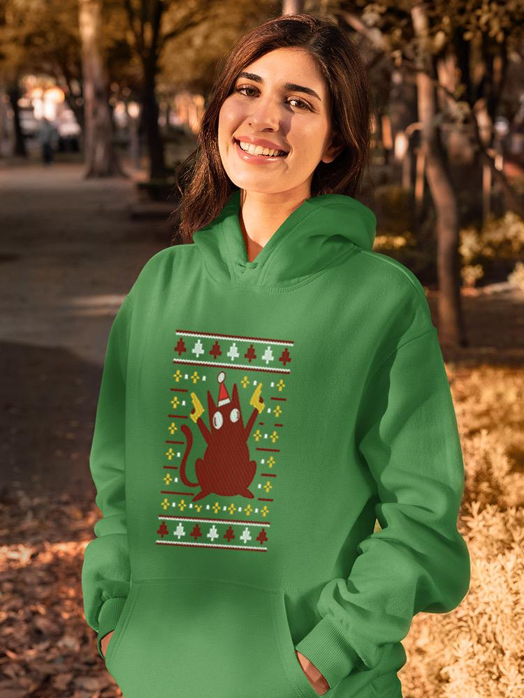 a woman wearing a green sweatshirt with a cartoon character on it