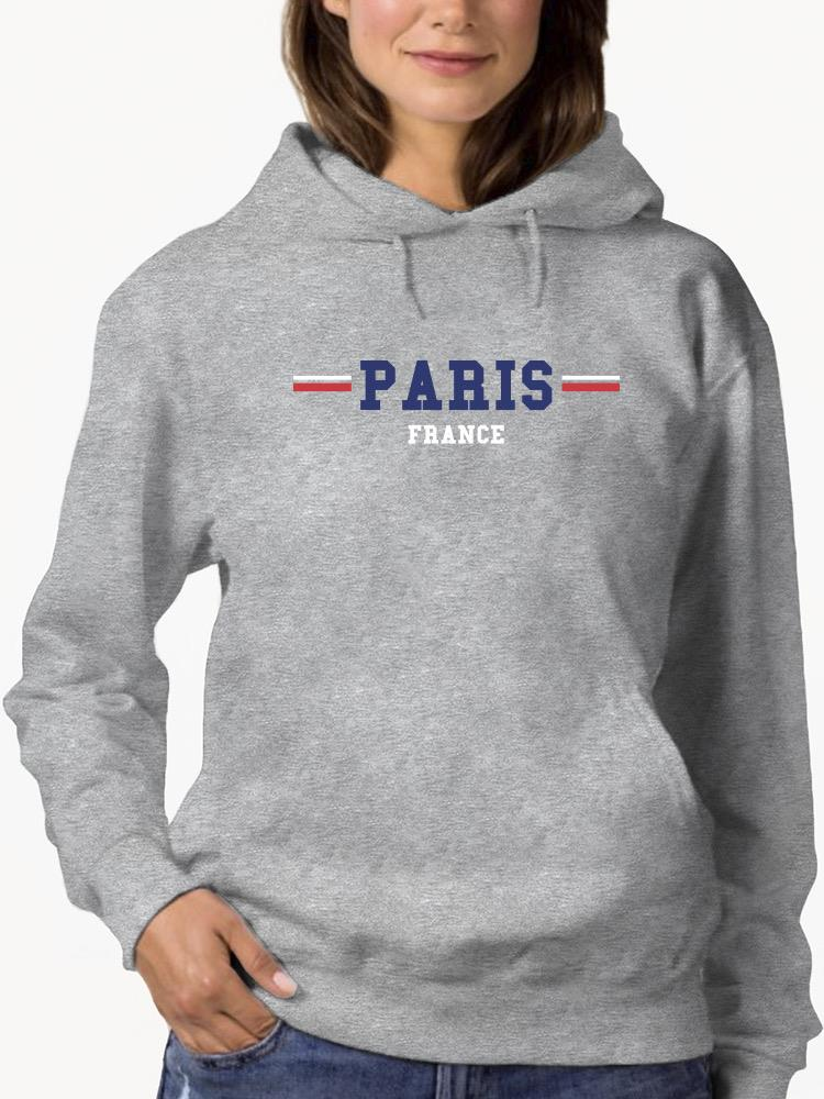 a woman wearing a grey sweatshirt