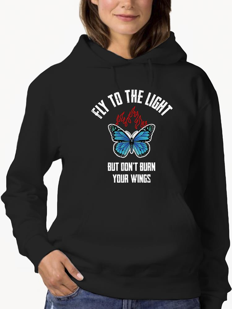 a person wearing a black hoodie with a blue butterfly