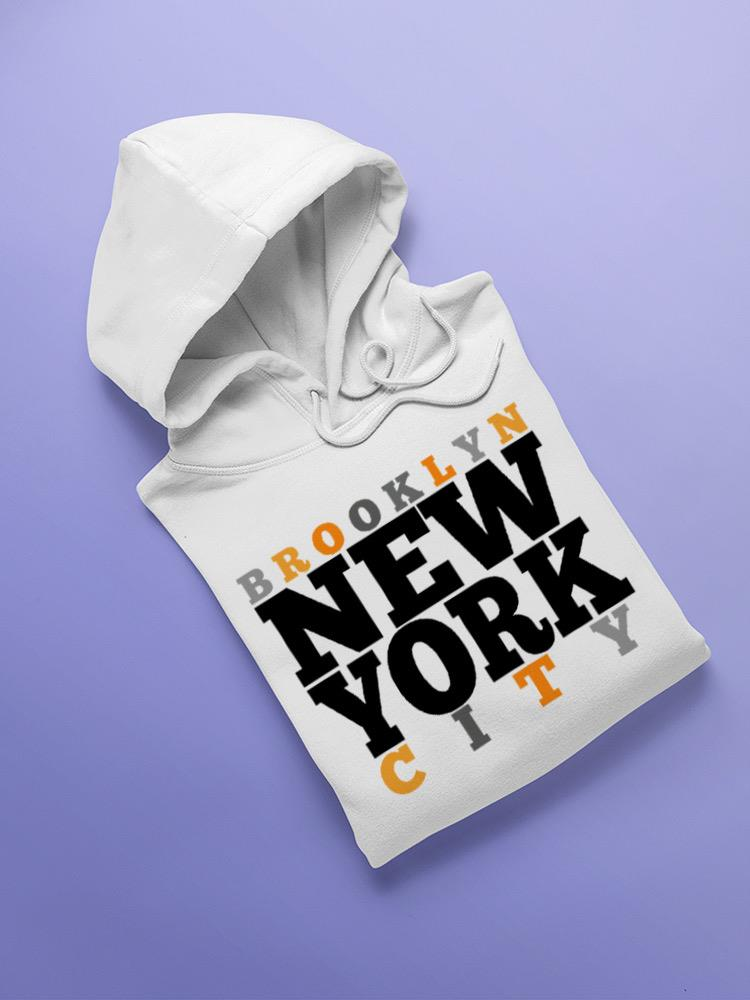 a white sweatshirt with black and orange text on it