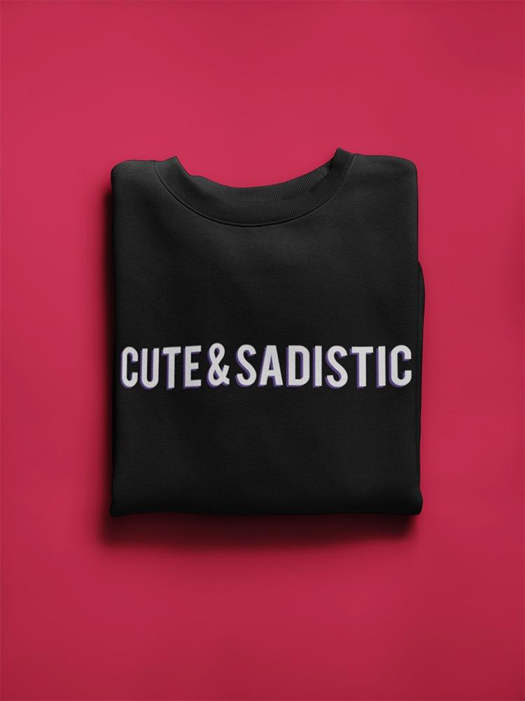 a black sweatshirt folded on a pink background