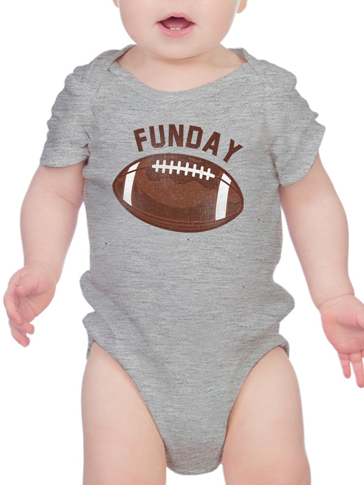 a baby wearing a grey bodysuit with a football on it