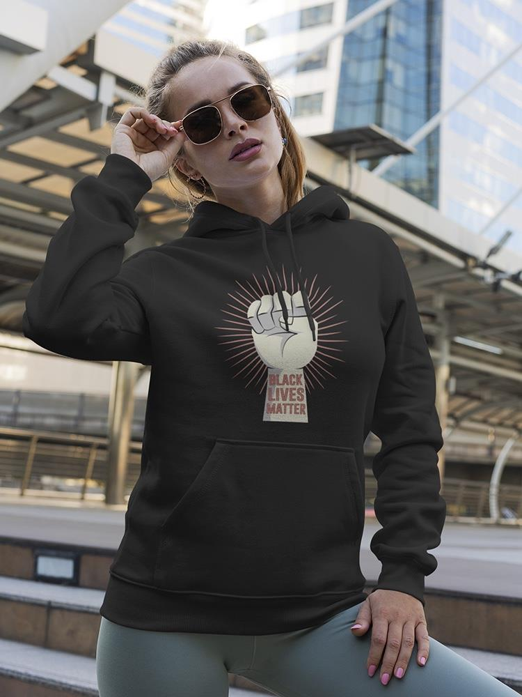 a woman wearing sunglasses and a black sweatshirt