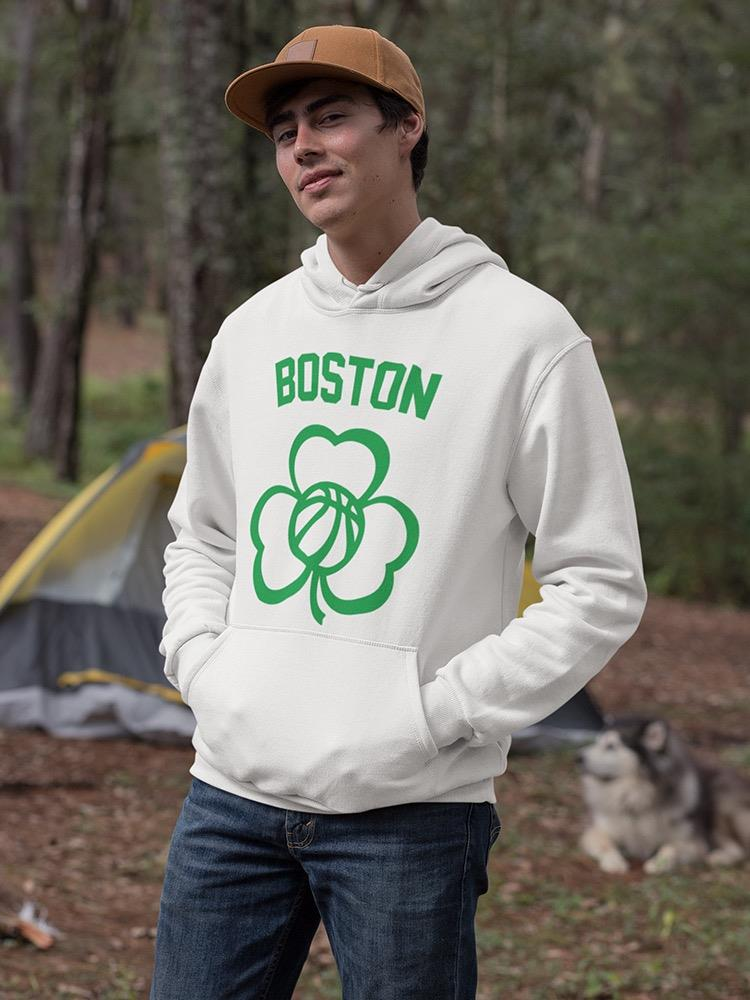 a man in a white sweatshirt with a dog in the background