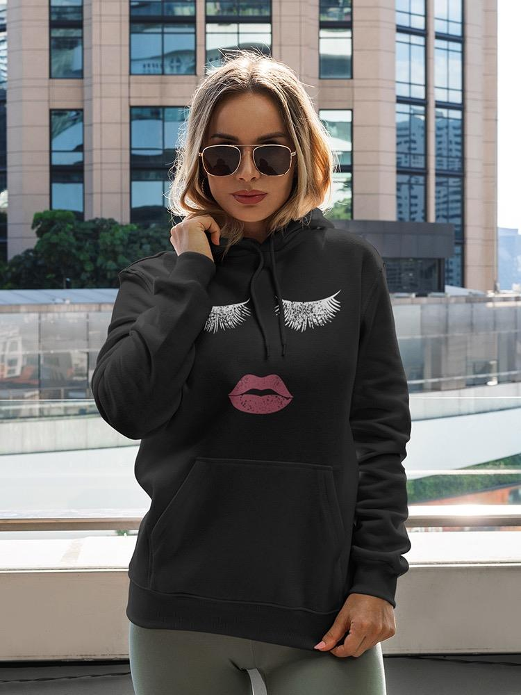a woman wearing sunglasses and a black hoodie