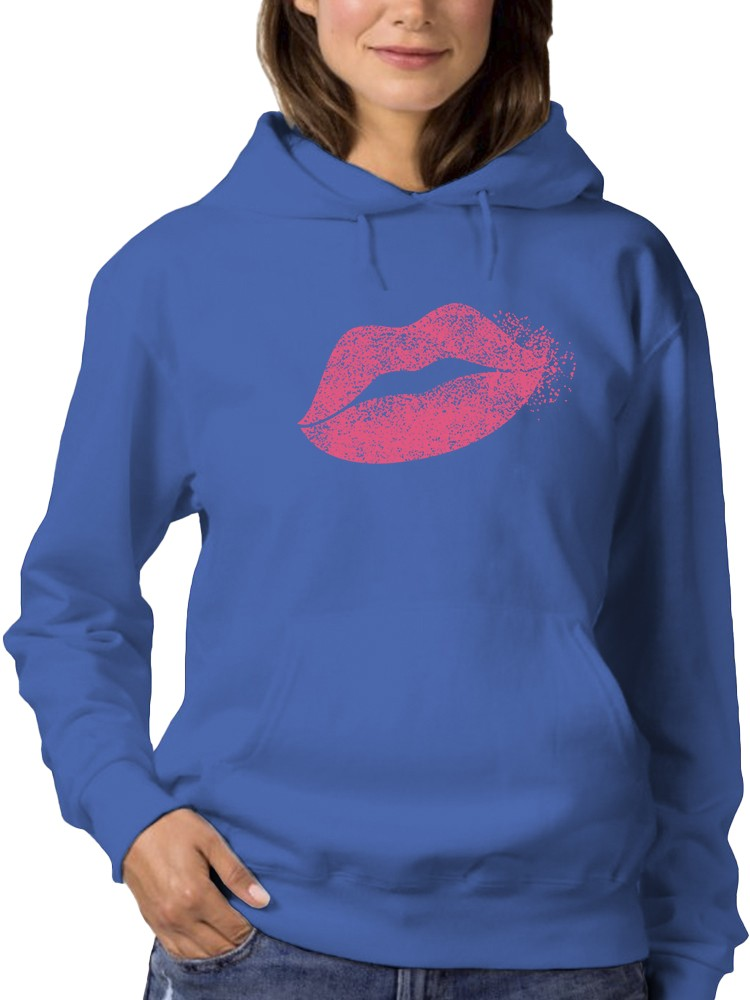 a woman wearing a blue sweatshirt with a pink lips print