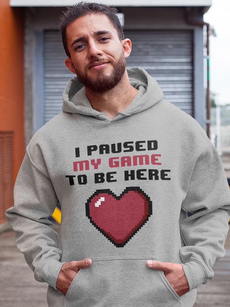 a man with beard wearing a grey sweatshirt with a heart and text