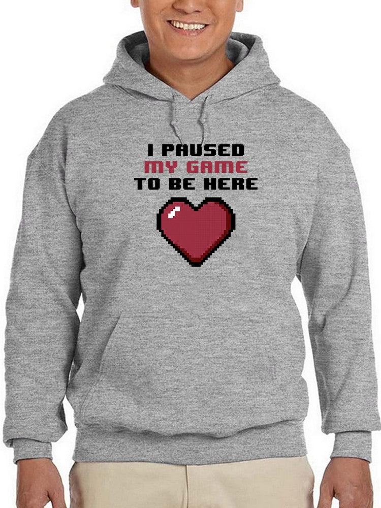 a person wearing a grey sweatshirt with a heart and text