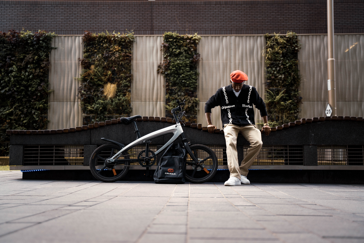 a man standing next to a bicycle