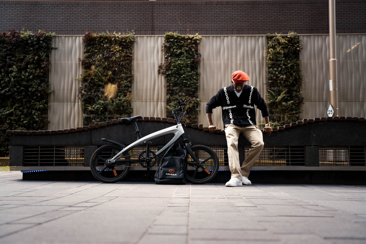 a man standing next to a bicycle