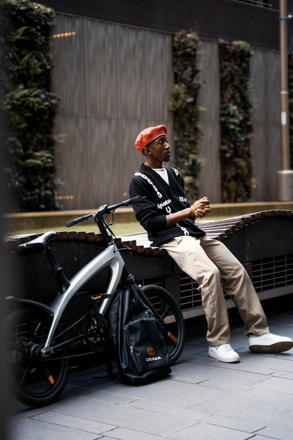a man sitting on a bench next to a bicycle