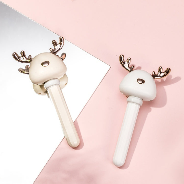 a pair of white reindeer horns on a pink and white surface