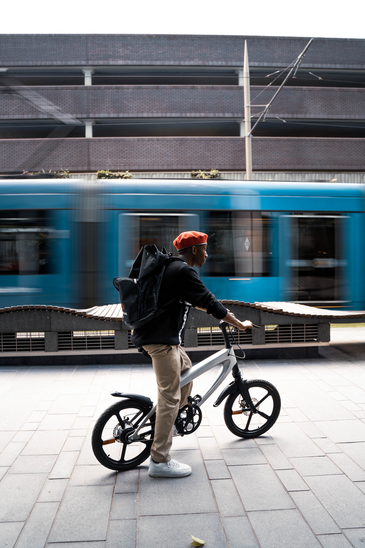 a man riding a bicycle next to a train