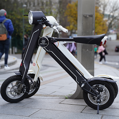 a black and white scooter on a sidewalk