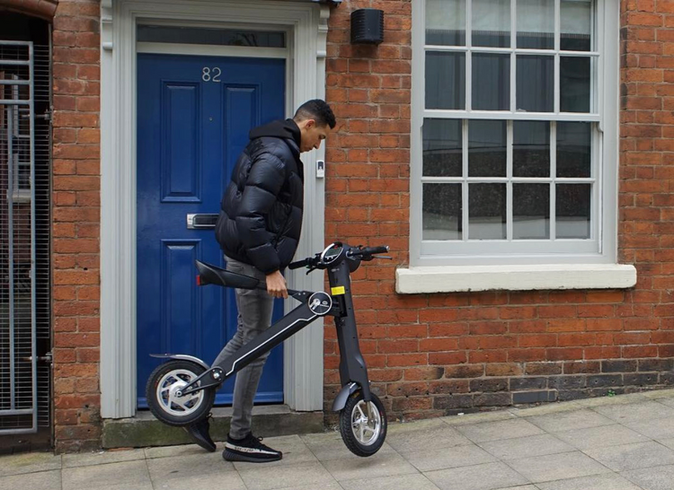 a man holding a scooter