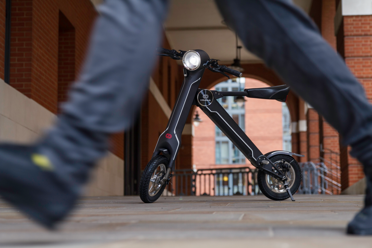 a black scooter with a round headlight