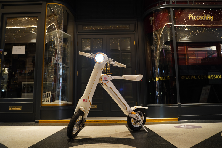 a white scooter in front of a building