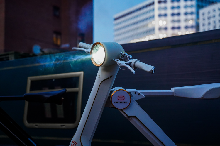 a white electric scooter with a light on