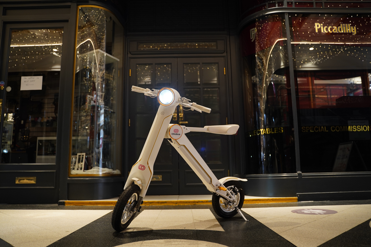 a white scooter in front of a building