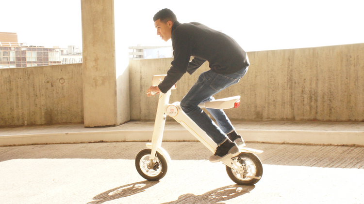 a man riding a white scooter