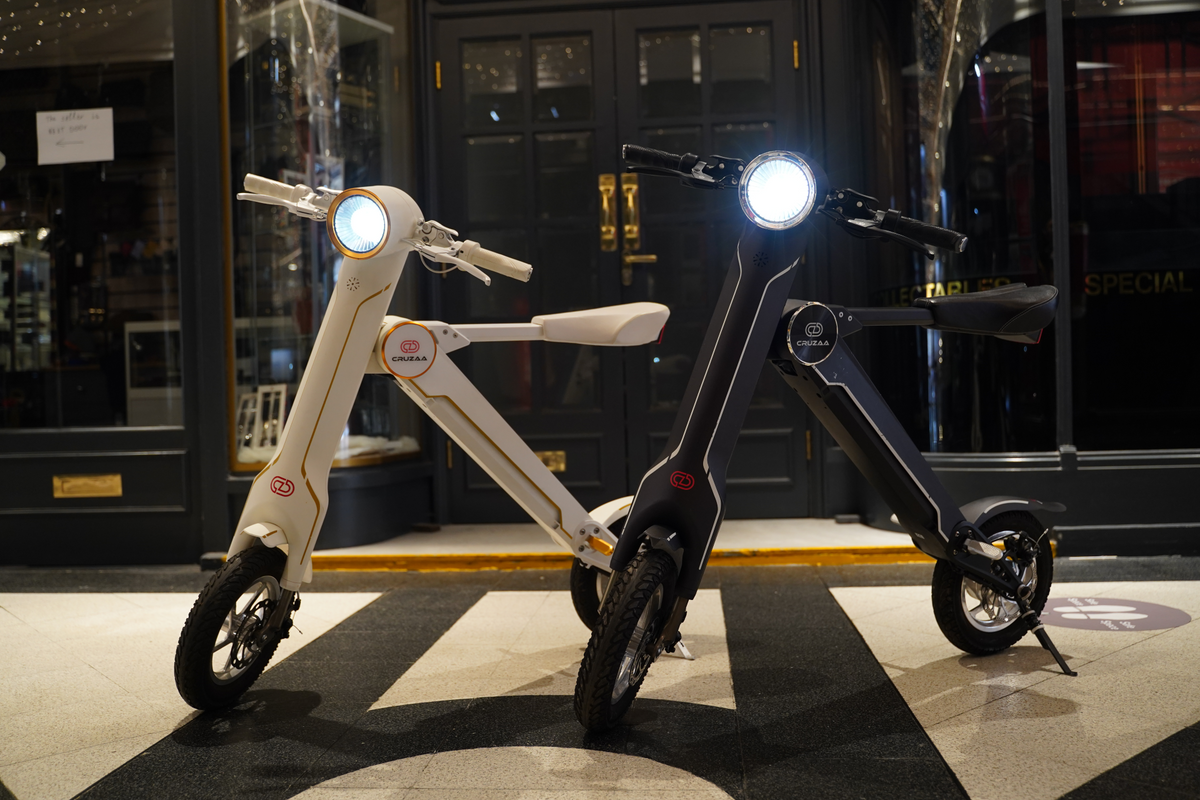 two scooters on a black and white tiled floor