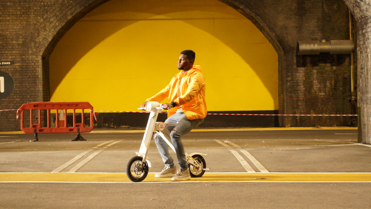 a man riding a scooter