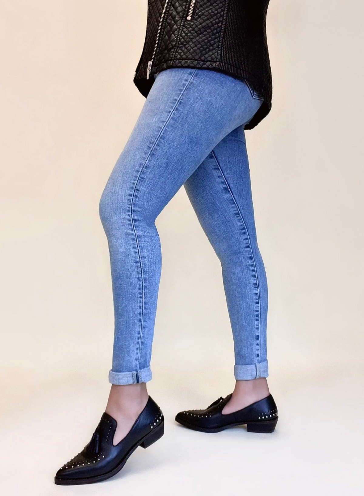 a woman's legs in jeans and shoes