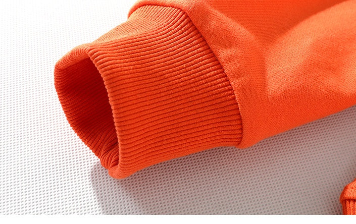 a close up of an orange sweater