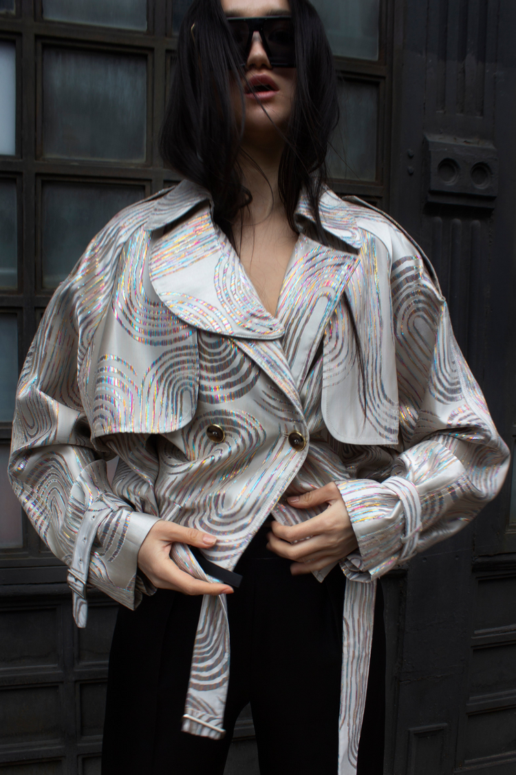 a woman wearing a silver jacket