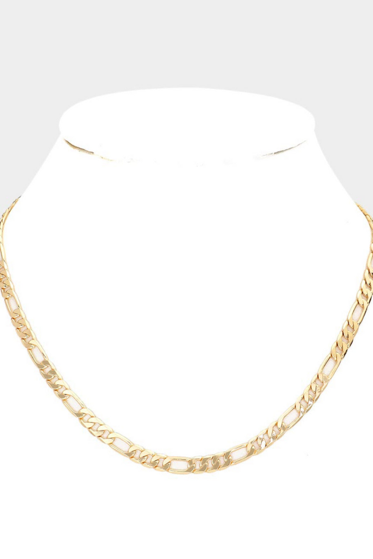 a gold chain on a white stand