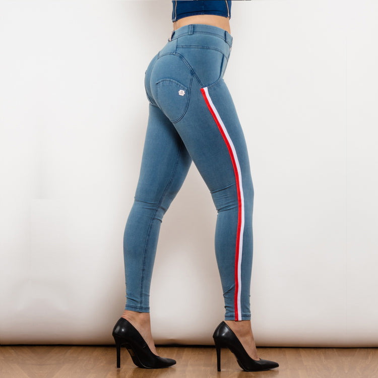 a woman wearing blue jeans and black high heels