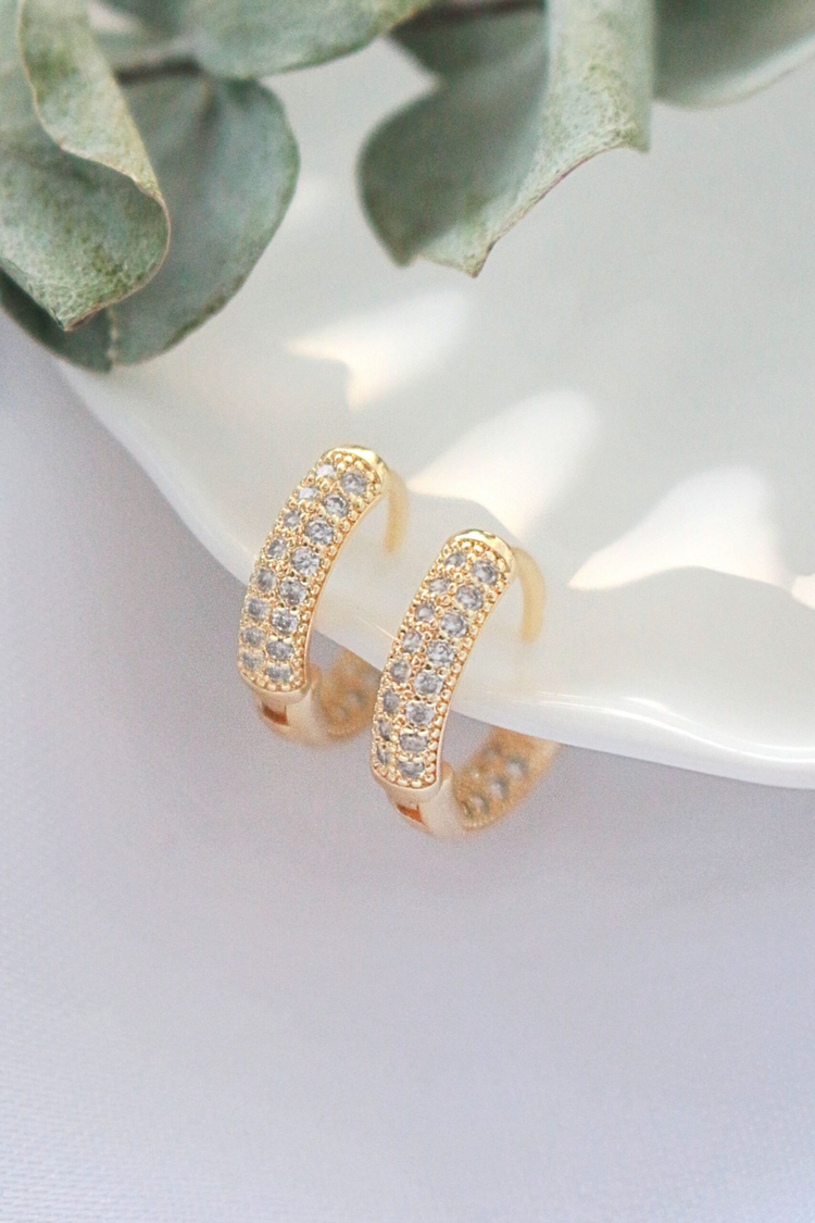 a pair of gold earrings with diamonds