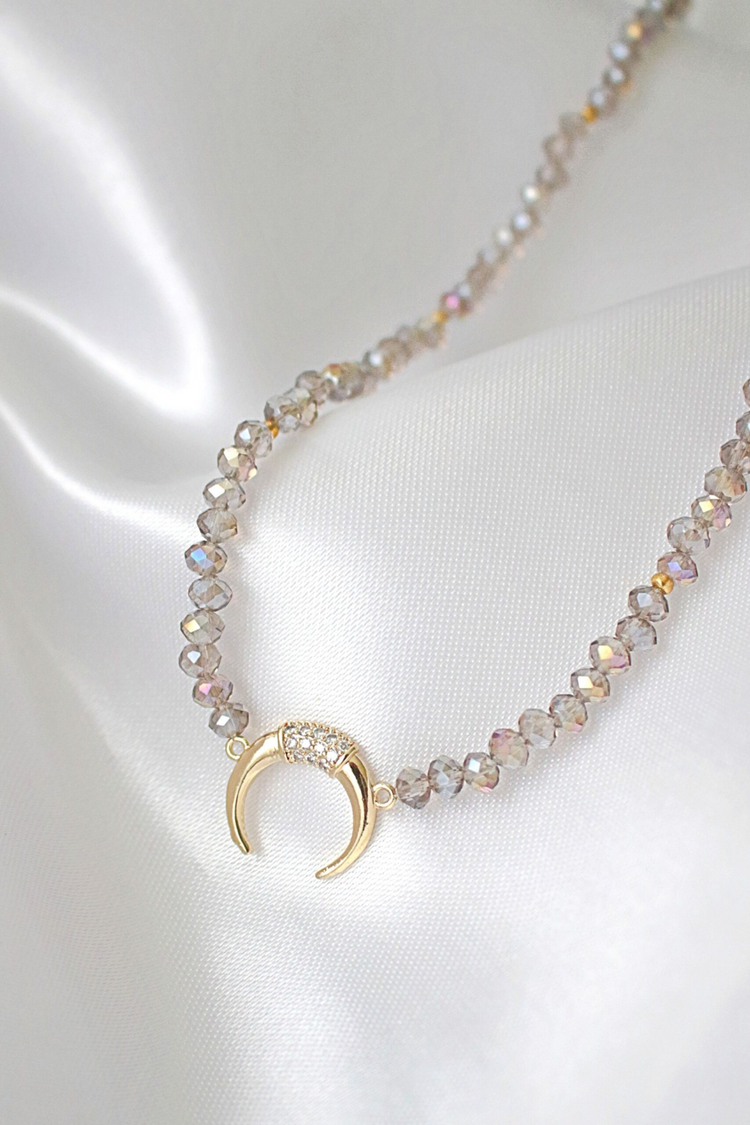 a necklace with a gold pendant