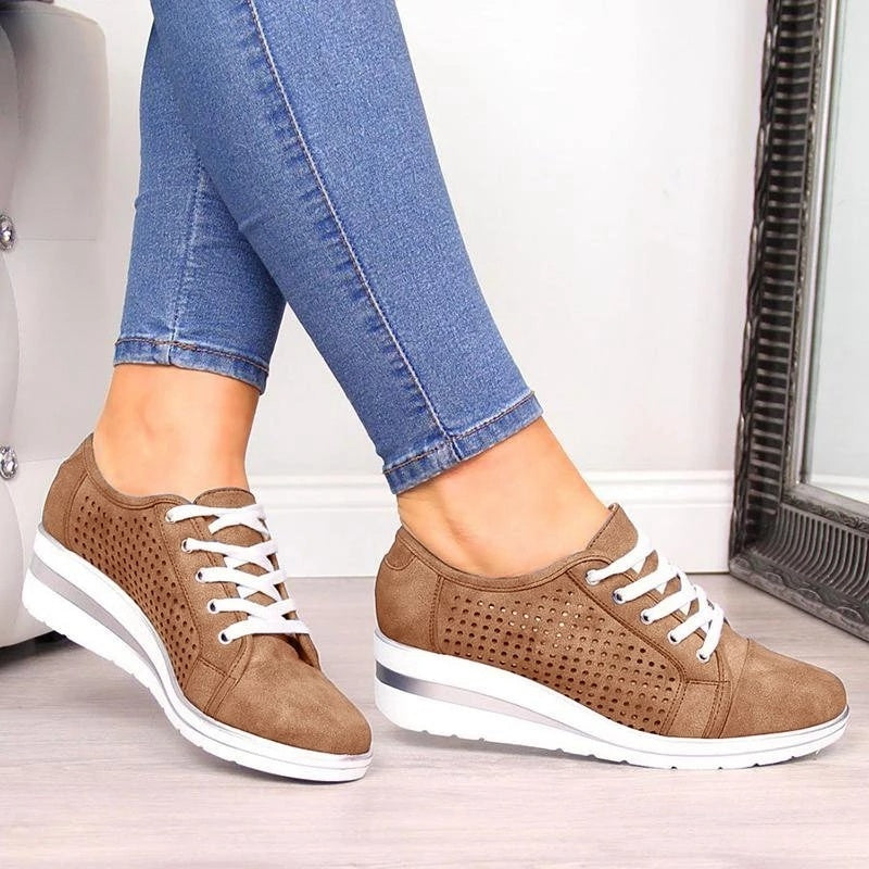 a person's legs wearing jeans and brown shoes
