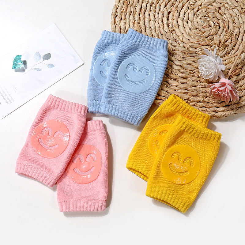 a group of knitted knee pads with smiley faces on them