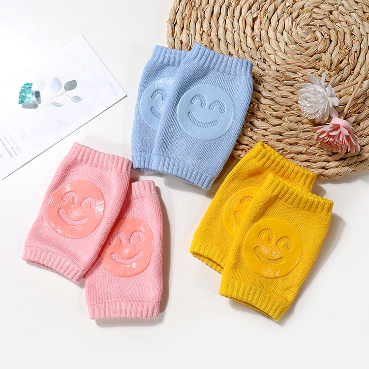 a group of knitted knee pads with smiley faces on them