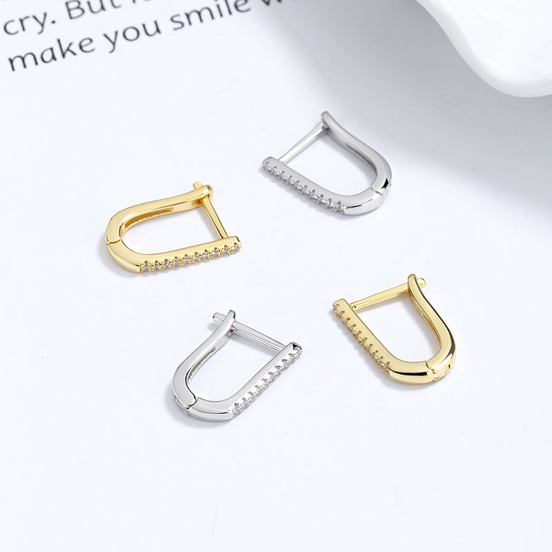a group of gold and silver earrings
