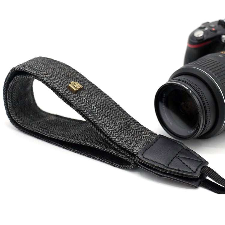 a camera strap with a strap attached to it