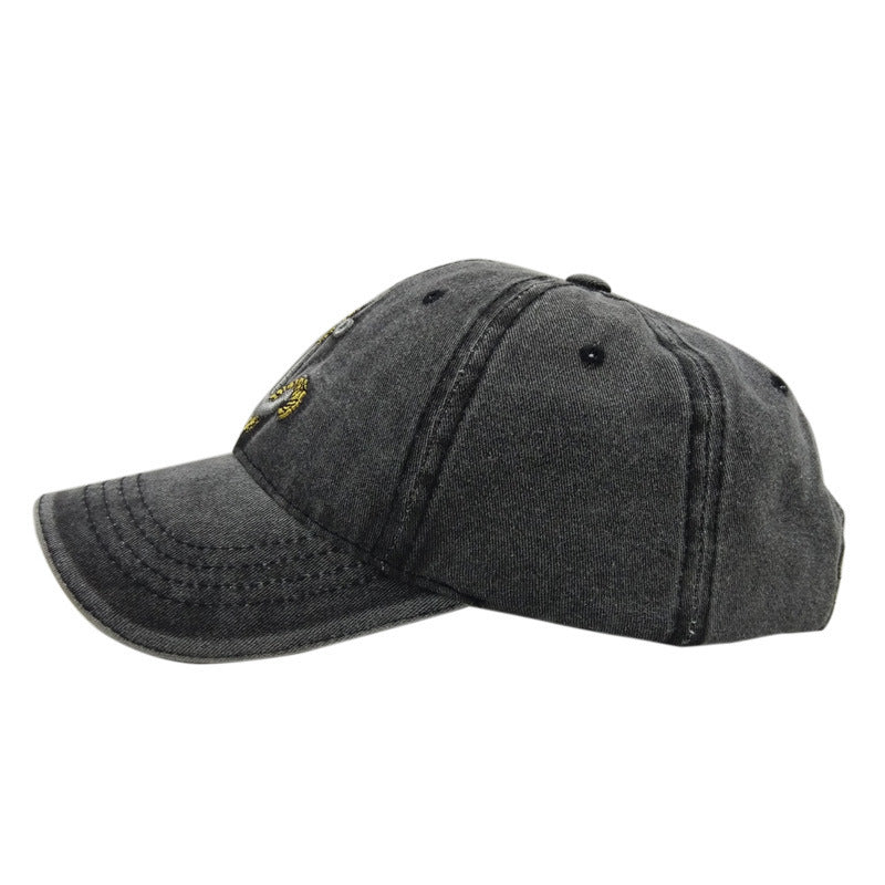 a black baseball cap with a yellow logo