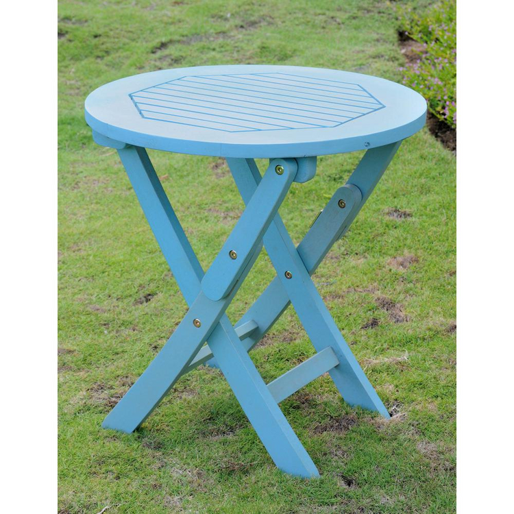 a small blue table in grass