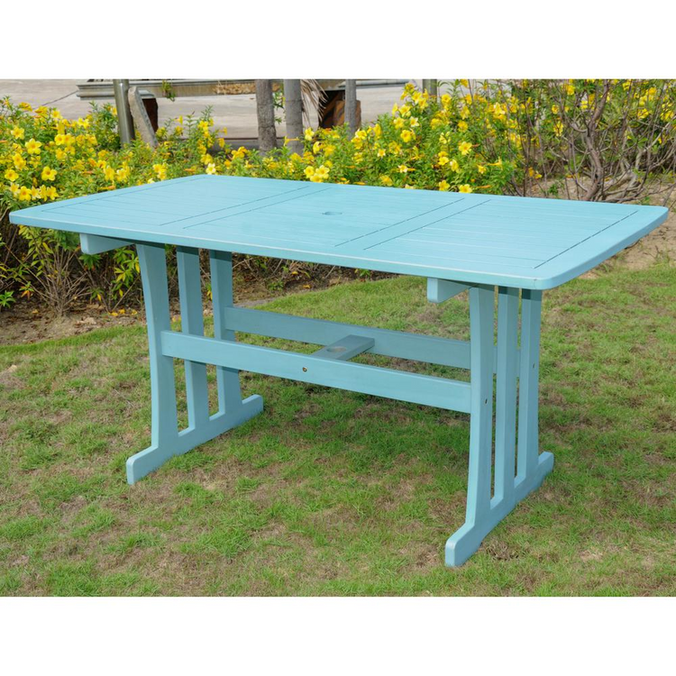 a blue table in a grassy area