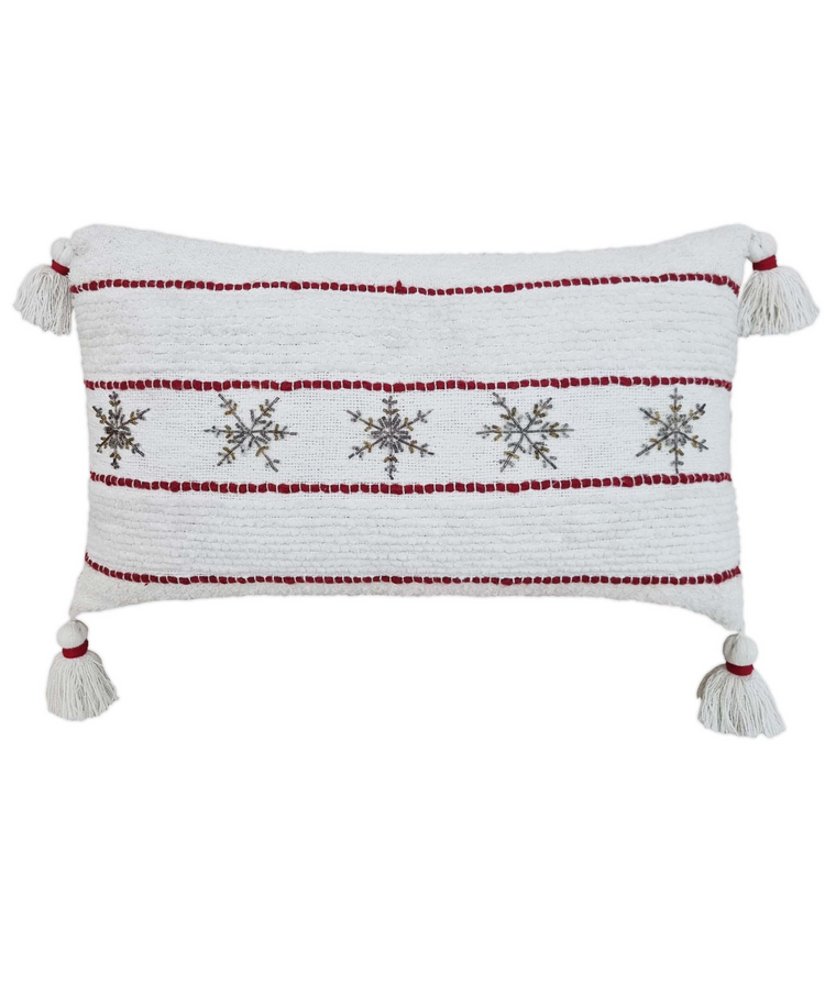 a white and red pillow with snowflakes