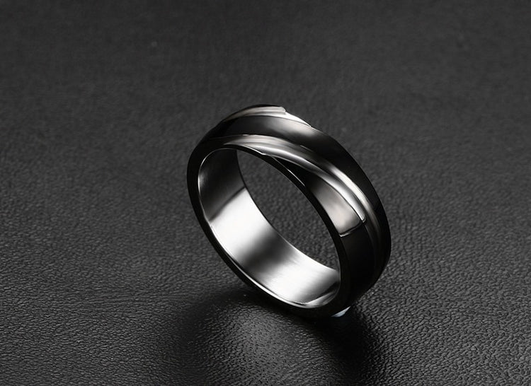 a silver ring on a black surface