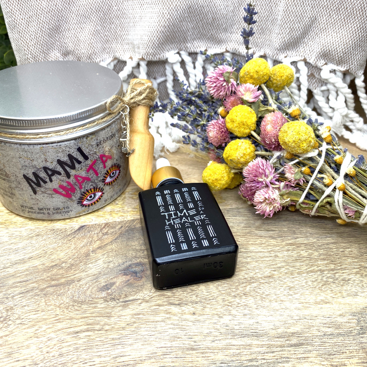a small black container next to a bunch of flowers